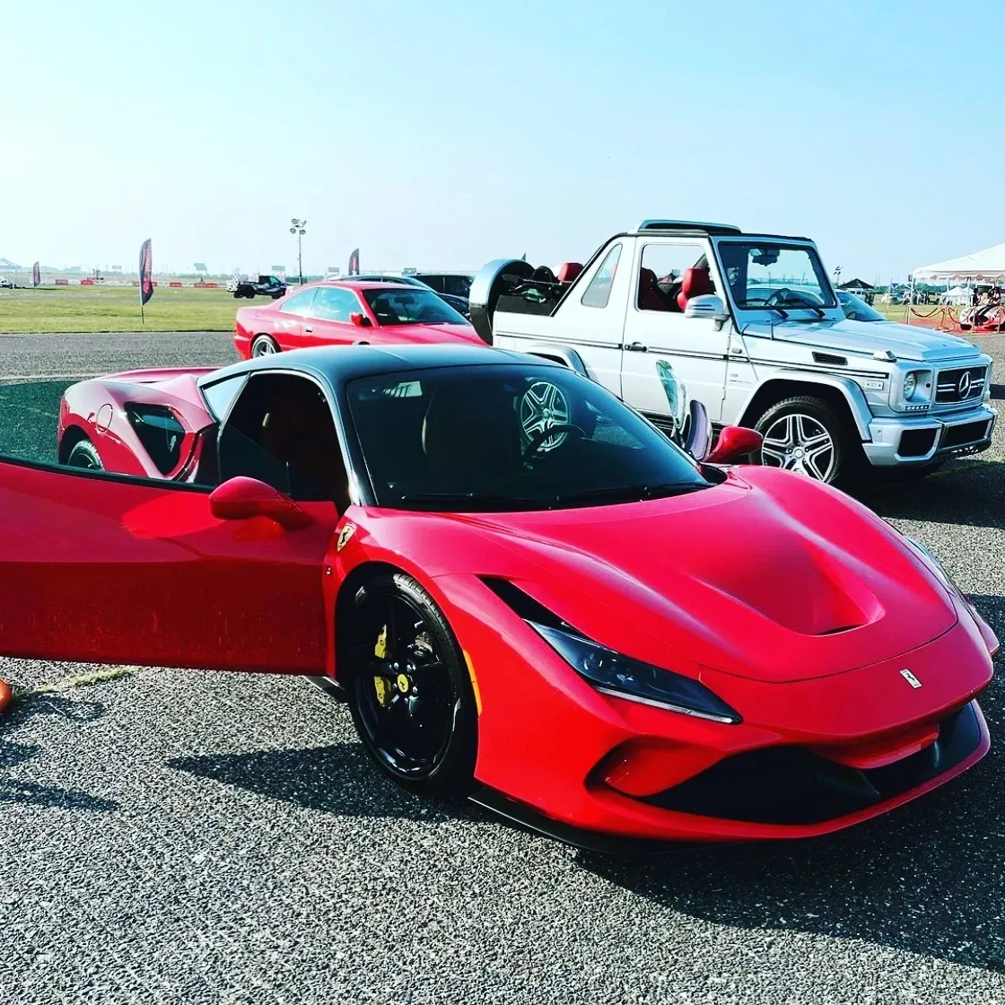 A shining trio of exotic vehicles showcasing speed, style, and meticulous auto detailing, with a sleek red sports car in the foreground, another futuristic model behind it, and a rugged luxury SUV completing the scene